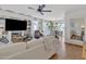 Open-concept living space featuring a built-in entertainment center, flowing into a dining area with backyard view at 9231 E Carmel Ave, Mesa, AZ 85208