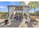 Outdoor patio with a pergola, draped curtains, and dining set at 9231 E Carmel Ave, Mesa, AZ 85208