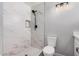 Bathroom boasts a luxe marble shower with niche, paired with a modern toilet at 1002 W Fairway Dr, Mesa, AZ 85201