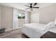 Bright bedroom with wood-look flooring and a modern ceiling fan at 1002 W Fairway Dr, Mesa, AZ 85201