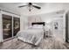 Lovely bedroom features backyard access, neutral decor, a ceiling fan, and an attached ensuite at 1002 W Fairway Dr, Mesa, AZ 85201