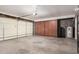 Organized garage with built-in cabinets and overhead door at 1002 W Fairway Dr, Mesa, AZ 85201