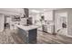 Bright kitchen boasts white cabinetry, an island cooktop, stainless appliances, and a farm sink at 1002 W Fairway Dr, Mesa, AZ 85201