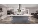 Bright kitchen features wood floors, an island cooktop, stainless appliances, and barstool seating at 1002 W Fairway Dr, Mesa, AZ 85201