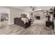 Open living room with decorative stone fireplace, built in shelves, wood look floors and neutral colors at 1002 W Fairway Dr, Mesa, AZ 85201