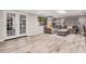 Cozy Living Room with wood floors, large sofa, recessed lights and french doors to exterior at 1002 W Fairway Dr, Mesa, AZ 85201