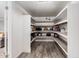 Walk-in pantry with ample shelving, ideal for storing kitchen appliances and bulk food supplies at 1002 W Fairway Dr, Mesa, AZ 85201