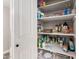 Walk-in pantry with white shelving units, offering storage for food, paper products, and sundries at 1002 W Fairway Dr, Mesa, AZ 85201