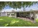 Lush backyard with well-kept lawn, and comfortable seating outside of the house at 10417 W Deanne Dr, Sun City, AZ 85351