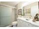 Updated bathroom with a white vanity, marble countertop, and a glass-enclosed shower at 10417 W Deanne Dr, Sun City, AZ 85351