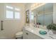 Bright bathroom with white vanity, shuttered windows, and walk-in shower providing a clean and refreshing space at 10417 W Deanne Dr, Sun City, AZ 85351