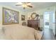 Bedroom displaying a ceiling fan, unique framed art and doorway leading to an ensuite dressing room with vanity at 10417 W Deanne Dr, Sun City, AZ 85351