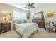 Cozy bedroom with a ceiling fan, a window with blinds, and matching furniture at 10417 W Deanne Dr, Sun City, AZ 85351