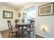 Charming dining area with hardwood floors, elegant decor, and a view to the bright kitchen at 10417 W Deanne Dr, Sun City, AZ 85351