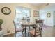 Cozy dining area with a unique table and chairs, decorative accents, and a view to the kitchen at 10417 W Deanne Dr, Sun City, AZ 85351