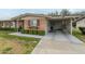 Charming single-story home with a carport, front landscaping, and mature trees at 10417 W Deanne Dr, Sun City, AZ 85351