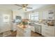 Bright kitchen featuring custom cabinets, stainless steel appliances, and wood flooring at 10417 W Deanne Dr, Sun City, AZ 85351