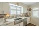 Kitchen featuring stainless steel appliances and white cabinets at 10417 W Deanne Dr, Sun City, AZ 85351