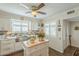 Bright kitchen featuring custom cabinets, stainless steel appliances, and wood flooring at 10417 W Deanne Dr, Sun City, AZ 85351