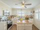 Bright kitchen featuring custom cabinets, stainless steel appliances, and wood flooring at 10417 W Deanne Dr, Sun City, AZ 85351
