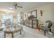 Bright living room with mirrored cabinet, decorative seating, and open view to the kitchen at 10417 W Deanne Dr, Sun City, AZ 85351