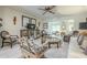 Spacious living room featuring elegant seating, decorative wall art, and an open layout at 10417 W Deanne Dr, Sun City, AZ 85351