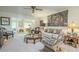 Bright living room featuring stylish furniture, elegant decor, and open access to another room at 10417 W Deanne Dr, Sun City, AZ 85351