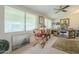 Sunlit home office featuring functional desks, comfortable chair, and ample natural light at 10417 W Deanne Dr, Sun City, AZ 85351