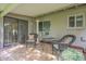 Relaxing covered patio with wicker furniture, privacy, and an exit to the house at 10417 W Deanne Dr, Sun City, AZ 85351