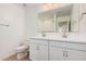 Bright bathroom features a double sink vanity with white cabinets and stone countertops at 11611 W Green Dr, Youngtown, AZ 85363