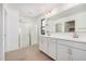 Bathroom featuring a glass-door shower and double vanity with white cabinets at 11611 W Green Dr, Youngtown, AZ 85363