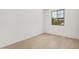 Bedroom with hardwood flooring and a large window bringing in light at 11611 W Green Dr, Youngtown, AZ 85363