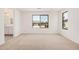 A bright bedroom with carpet and natural light from the windows, and a bathroom area at 11611 W Green Dr, Youngtown, AZ 85363