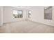 A large bedroom with neutral carpeting, large windows with an exterior view at 11611 W Green Dr, Youngtown, AZ 85363