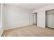A carpeted bedroom with a door to a walk-in closet at 11611 W Green Dr, Youngtown, AZ 85363