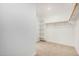 A carpeted walk-in closet with white shelving and a hanging rod for optimal storage at 11611 W Green Dr, Youngtown, AZ 85363