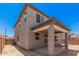 Exterior angle showcases the home's stucco siding, roofline, and covered patio in the backyard at 11611 W Green Dr, Youngtown, AZ 85363
