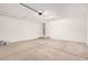 Spacious two-car garage with concrete floor, white walls, and garage door opener at 11611 W Green Dr, Youngtown, AZ 85363