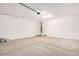 Spacious two-car garage with concrete floor, white walls, and garage door opener at 11611 W Green Dr, Youngtown, AZ 85363