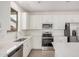 Bright kitchen featuring stainless steel appliances, white cabinets, and subway tile backsplash at 11611 W Green Dr, Youngtown, AZ 85363