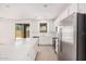 Spacious kitchen with an island, stainless steel appliances, and sliding doors to the backyard at 11611 W Green Dr, Youngtown, AZ 85363