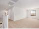 Large, open living room features neutral carpeting and a window with views of the neighborhood at 11611 W Green Dr, Youngtown, AZ 85363