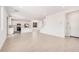 Open-concept living area with tile flooring and a view of the kitchen and staircase at 11611 W Green Dr, Youngtown, AZ 85363