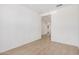 A white room with hard wood floors, base boards and an open door frame at 11611 W Green Dr, Youngtown, AZ 85363