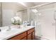 Bright bathroom featuring double sinks, modern fixtures, and a glass-enclosed shower at 1414 W Alder Rd, Queen Creek, AZ 85140