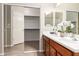 Bathroom with double sinks, a sliding mirror, and a door that leads into the walk in closet at 1414 W Alder Rd, Queen Creek, AZ 85140