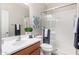 Bathroom featuring white vanity, glass enclosed shower, toilet, and modern fixtures at 1414 W Alder Rd, Queen Creek, AZ 85140