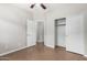 Bedroom with closet featuring tile flooring, neutral walls, and a ceiling fan with light at 1414 W Alder Rd, Queen Creek, AZ 85140