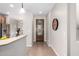Bright entryway with tile floors, designer clock and decorative front door at 1414 W Alder Rd, Queen Creek, AZ 85140