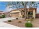 Charming home featuring a well-kept yard with lush landscaping and a covered entryway at 1414 W Alder Rd, Queen Creek, AZ 85140